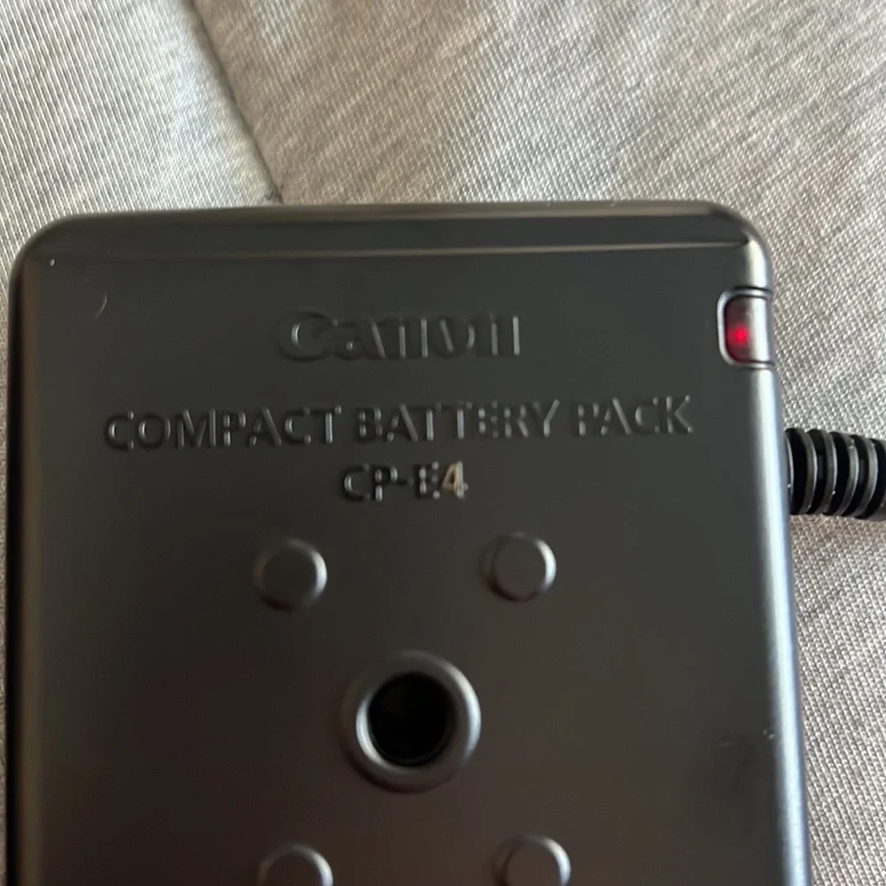 Canon batter pack with case and camera frame with flashgun cable